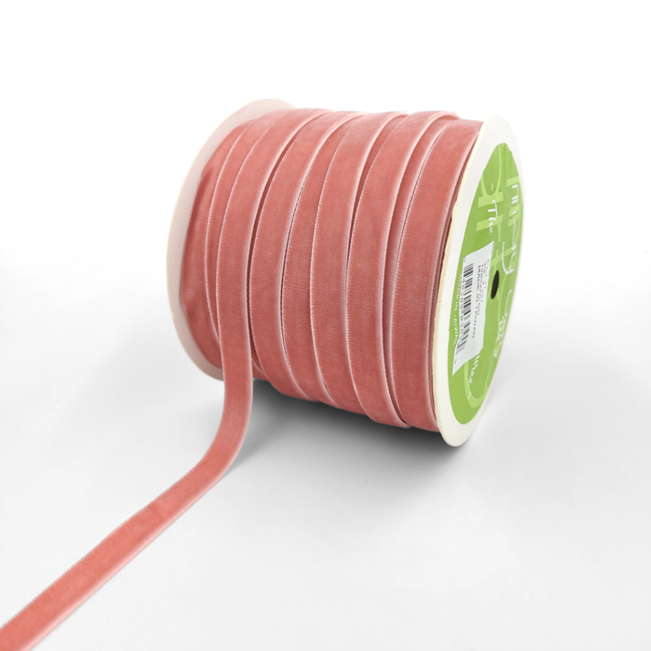 A spool of pink velvet ribbon with woven edge 3/8"