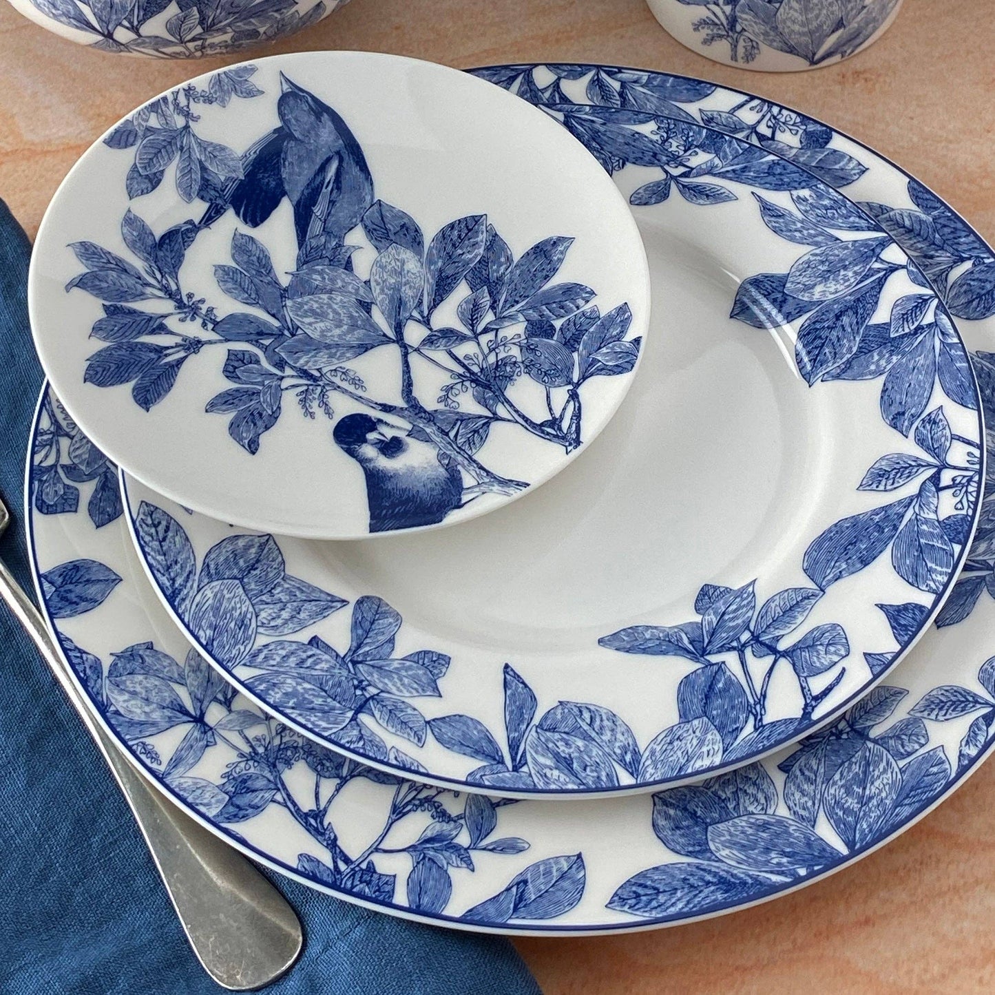 Set of blue and white patterned plates on a wooden table