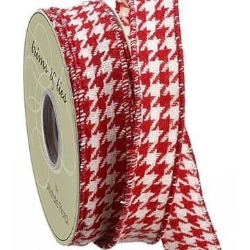 A roll of houndstooth pattern ribbon in white and red, unwrapped and displaying the pattern.