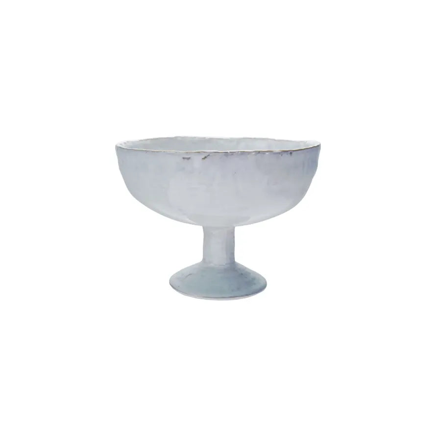 A white stoneware footed bowl with a reactive crackle glaze