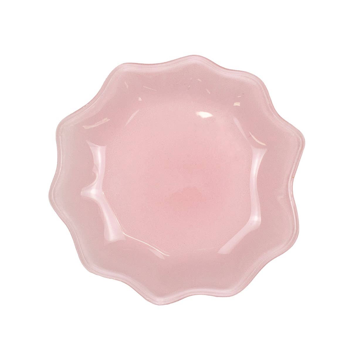 Pink ceramic plate with scalloped edge on a white background