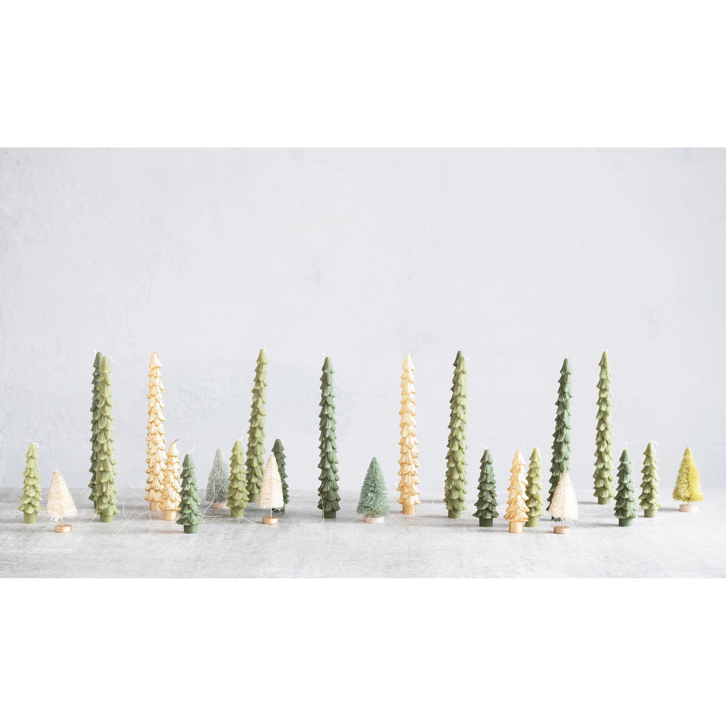 Model trees in a snowy landscape with a light gray background