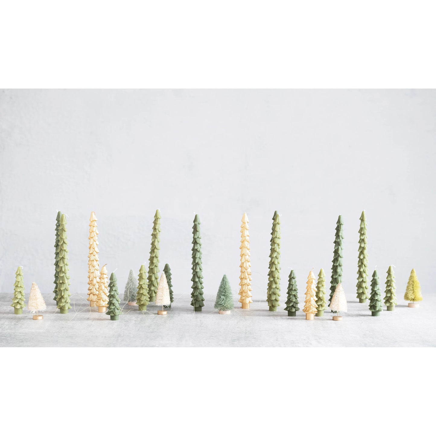 Model trees in a snowy landscape with a light gray background