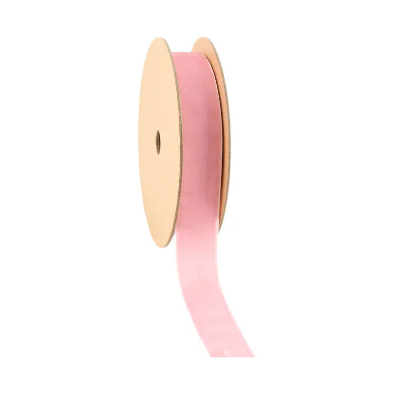 Spool of pink ribbon on a white background