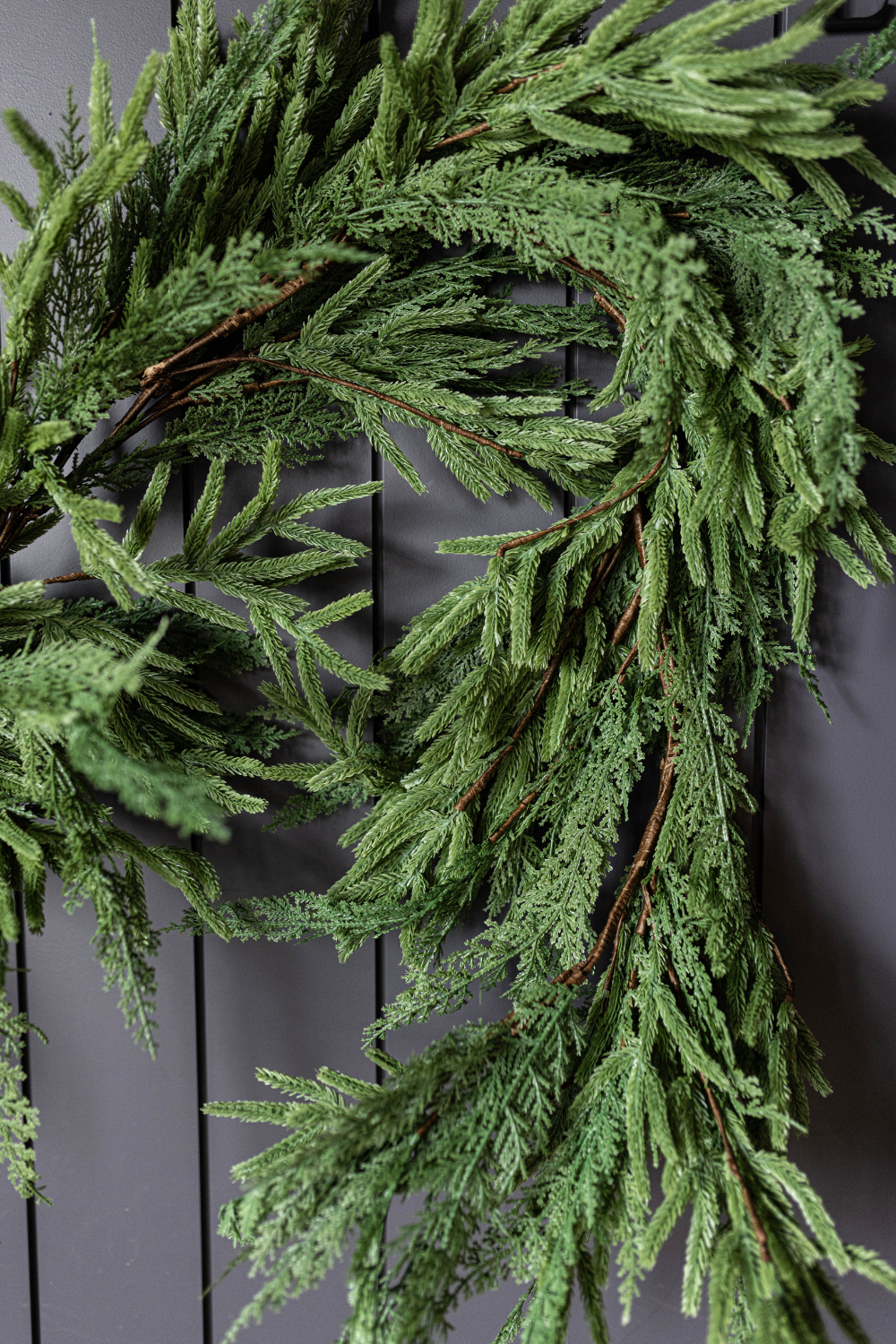 Green wreath on a dark wooden door