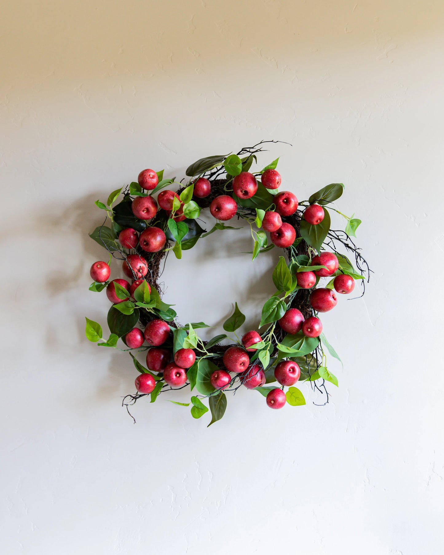 24 INCH RED APPLE AND TWIG W/FOLIAGE WREATH ON GRAPEVINE BASE