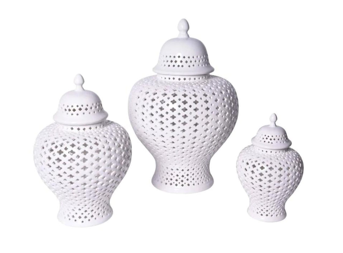 Three white porcelain ginger jars in different sizes, each featuring an intricate hand-carved lattice pattern and a glossy white glaze finish.
