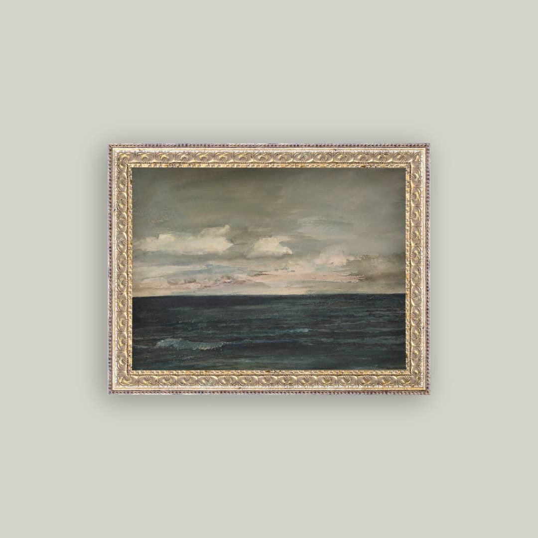 Framed painting of a seascape with a cloudy sky on a light gray wall.