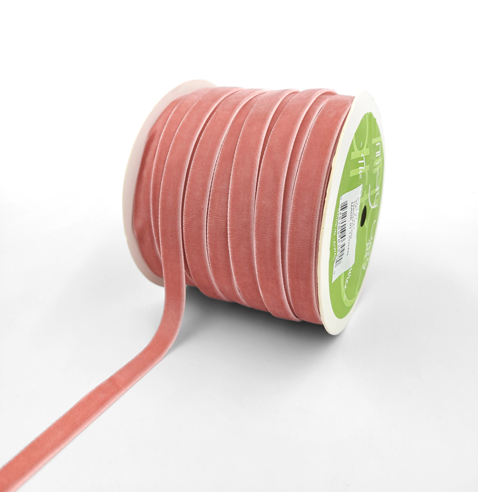 A spool of pink velvet ribbon with woven edge 3/8"
