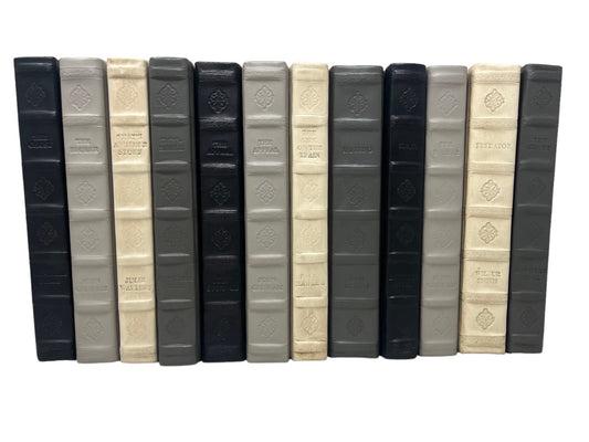4 Vol. Assorted Leather Bound Books in Dark and Neutral Colors