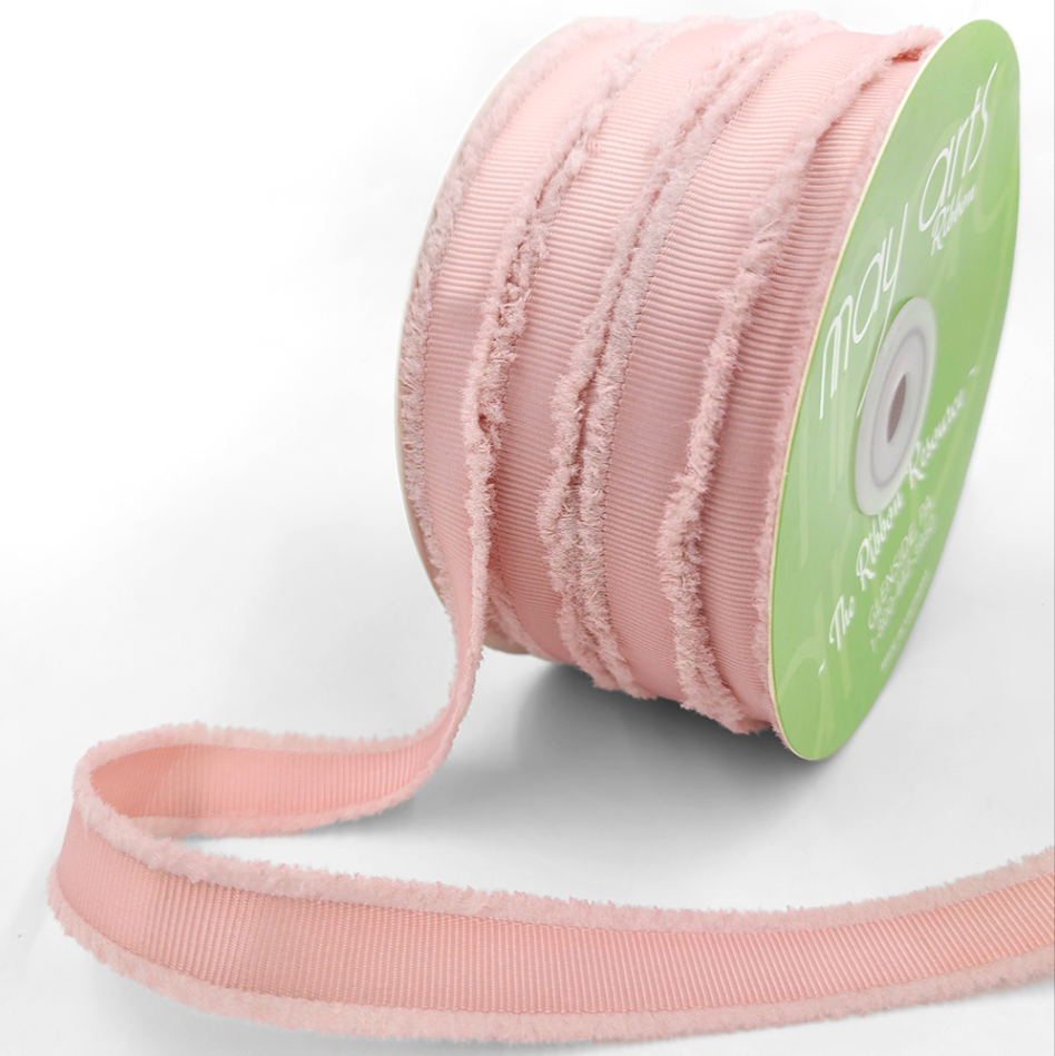 A spool of mauve-colored fuzzy grosgrain ribbon.