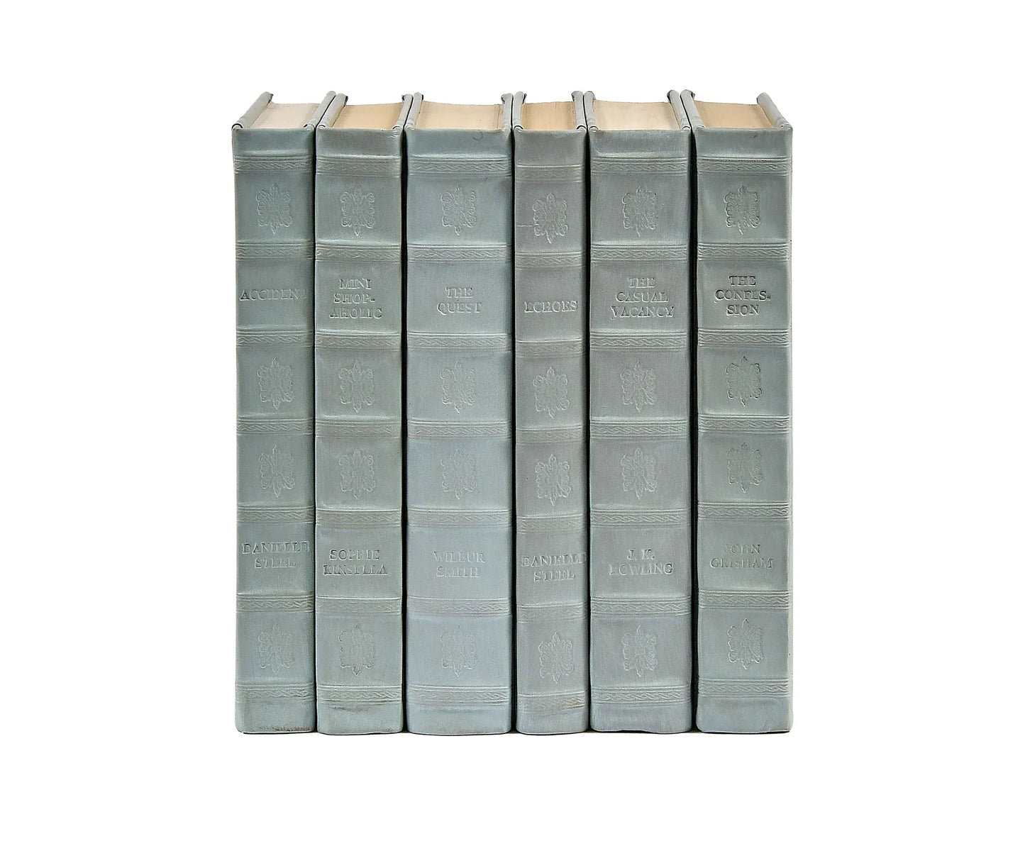 A set of light blue leather bound decorative books standing upright and arranged next to each other.