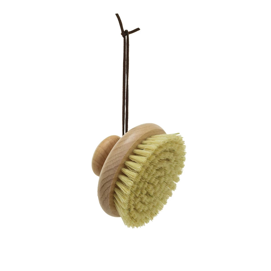 A beech wood body brush with a round handle and a leather tie 