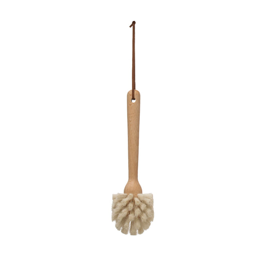 A beech wood dish brush with a leather strap attached to its handle, isolated on a white background.