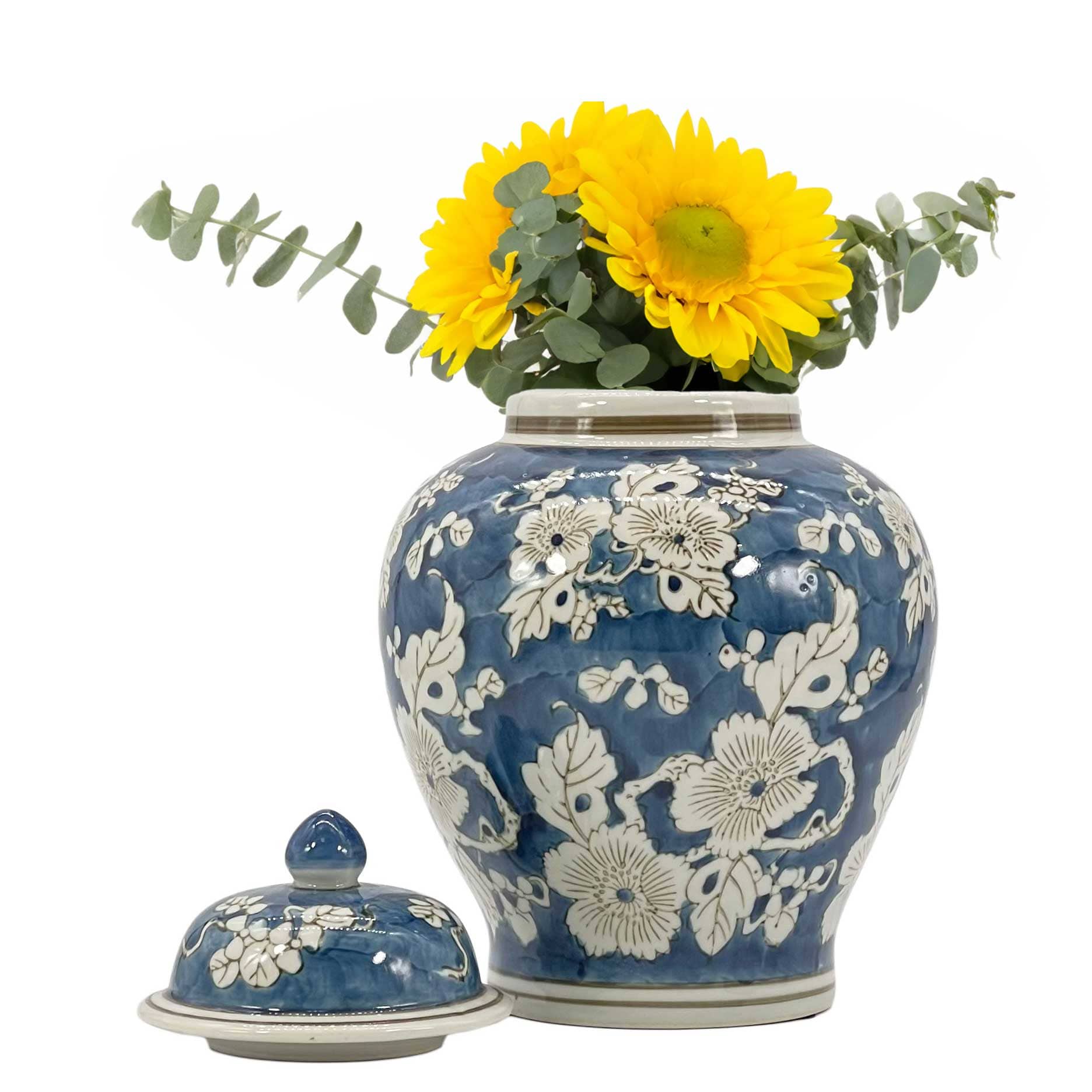 Blue floral-patterned vase with sunflowers on a white background