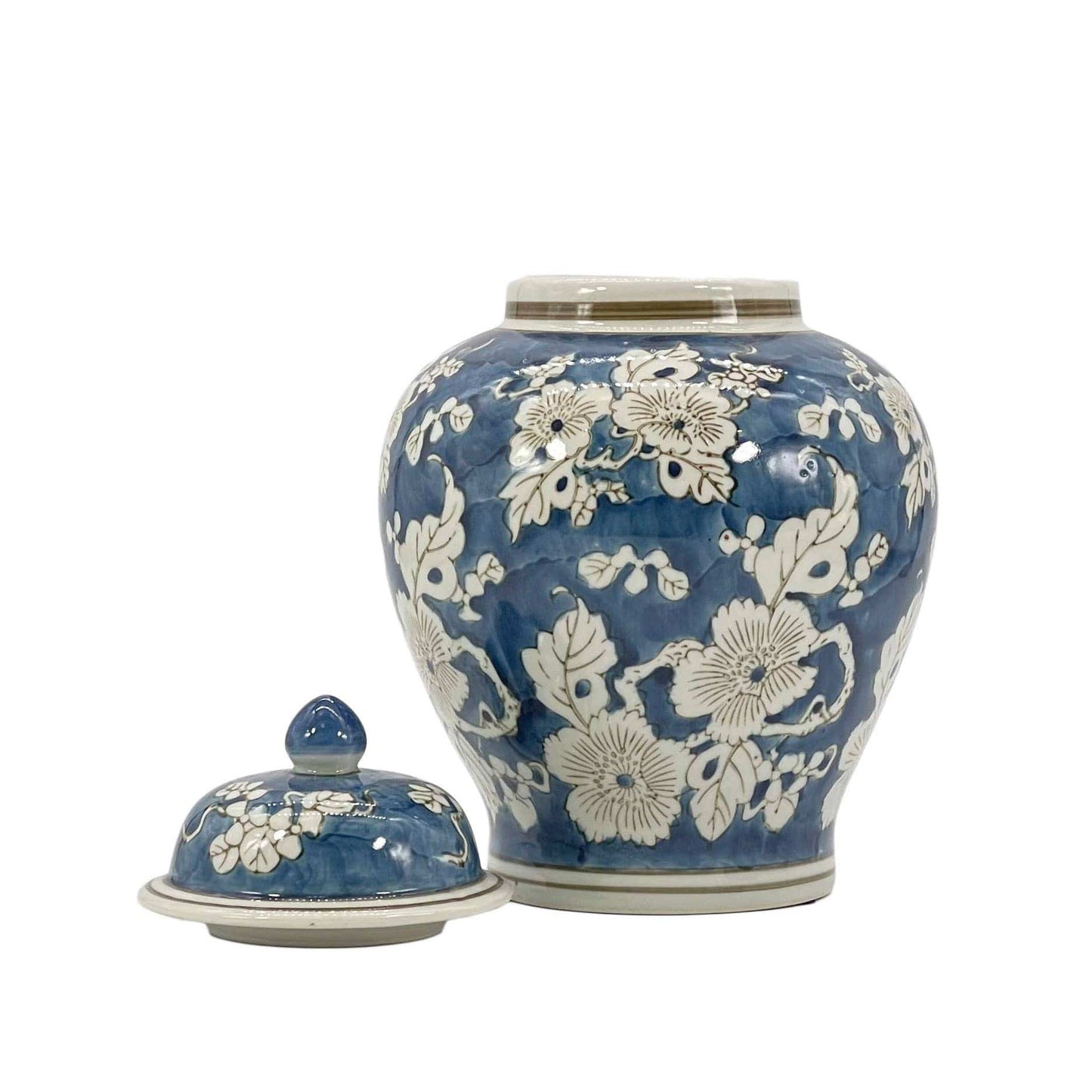 Blue ceramic jar with white floral patterns on a white background