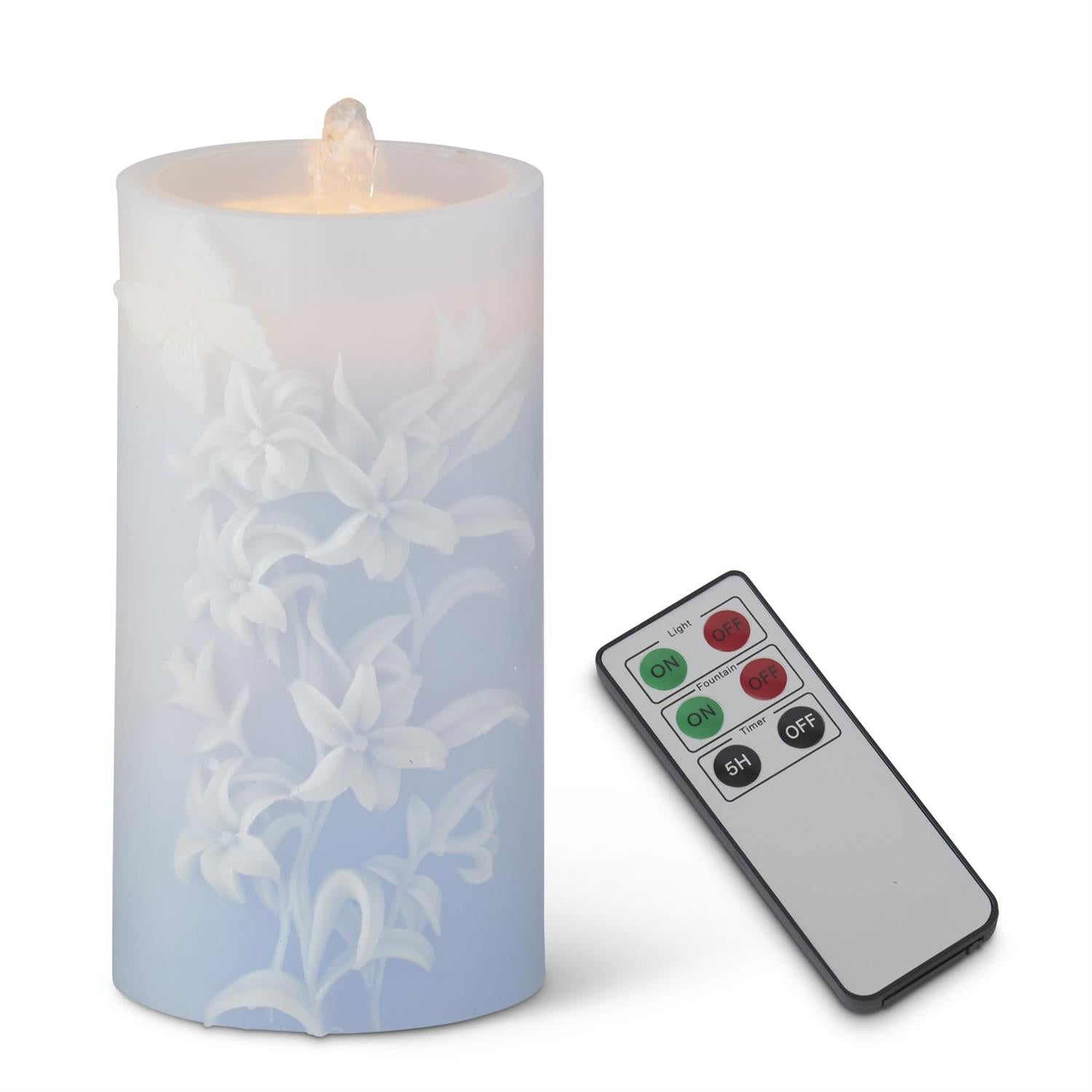 LED candle with floral design and remote control on a white background
