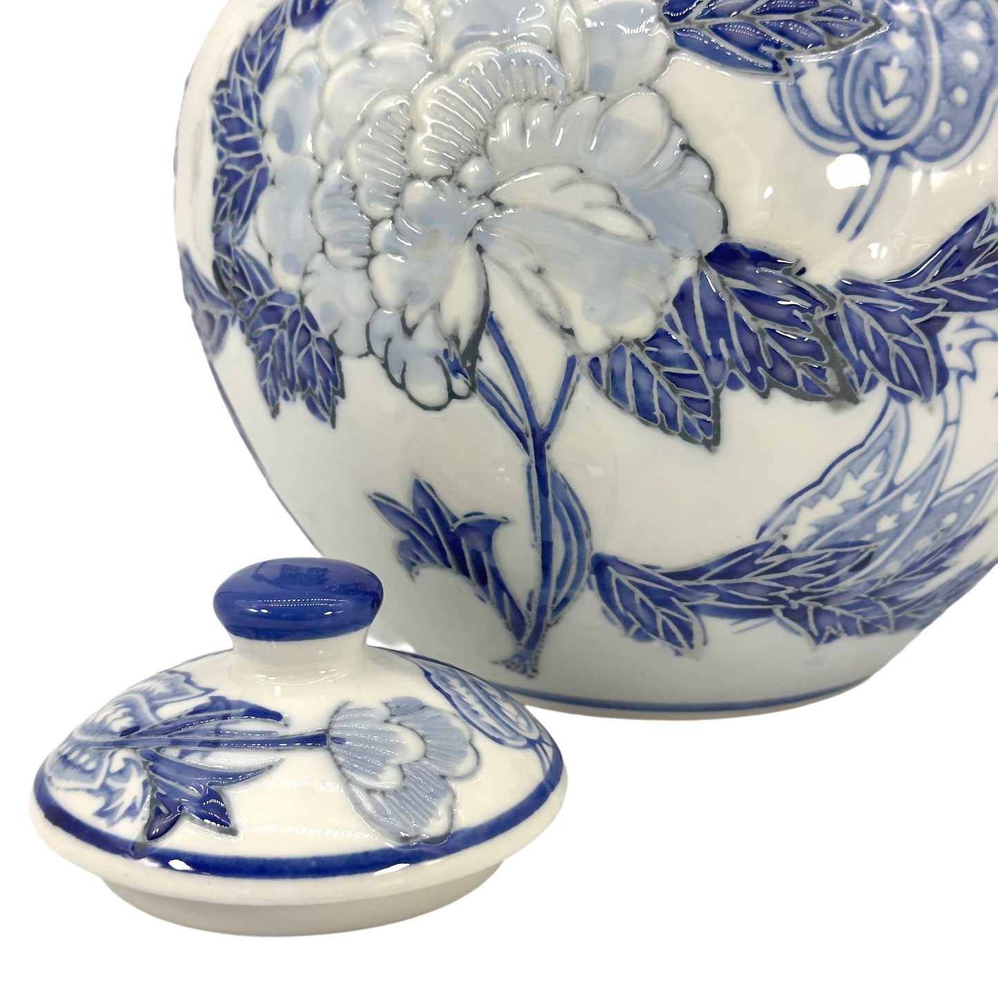 Ceramic jar with blue floral design on a white background