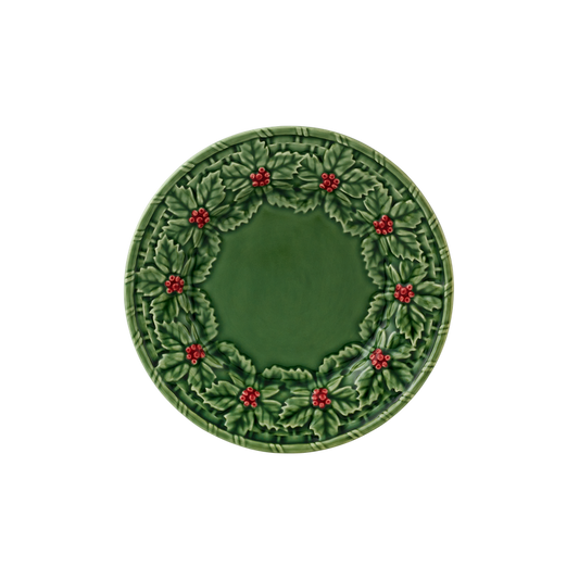 Green plate with holly design on a white background