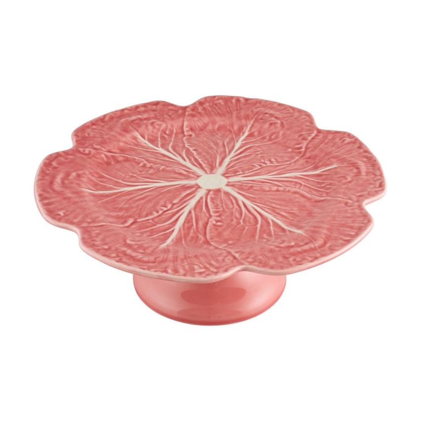 Pink cake stand with cabbage leaf design on a white background