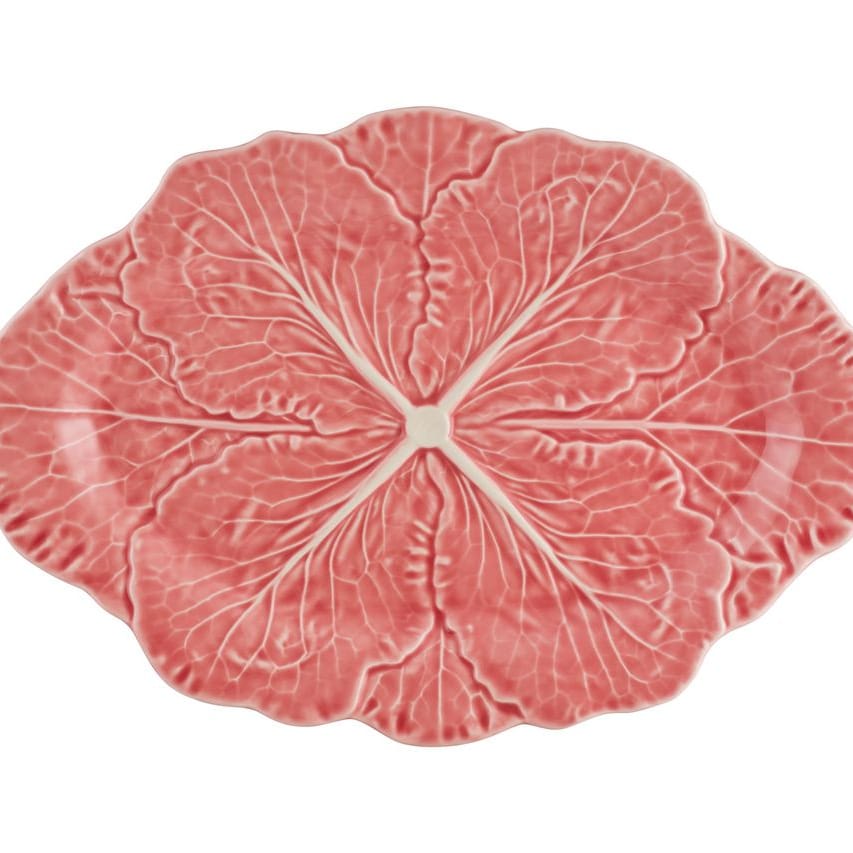 Pink ceramic platter with cabbage pattern on a white background
