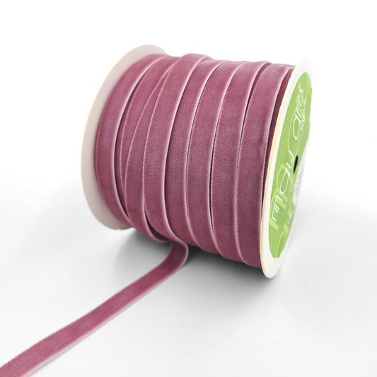 A spool of 3/8 inch classic velvet ribbon with a woven edge, displayed in a wood rose color.