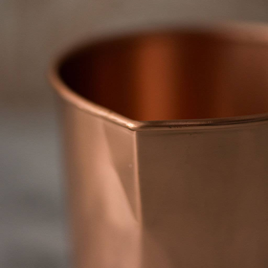 Copper measuring cup with gold handle