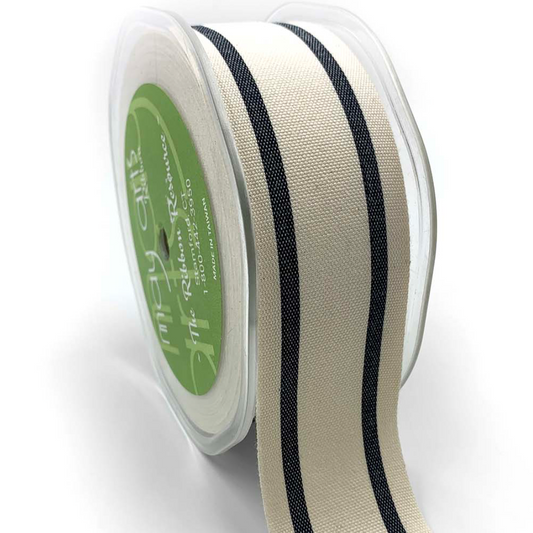 Spool of ribbon with black and beige stripes on a white background
