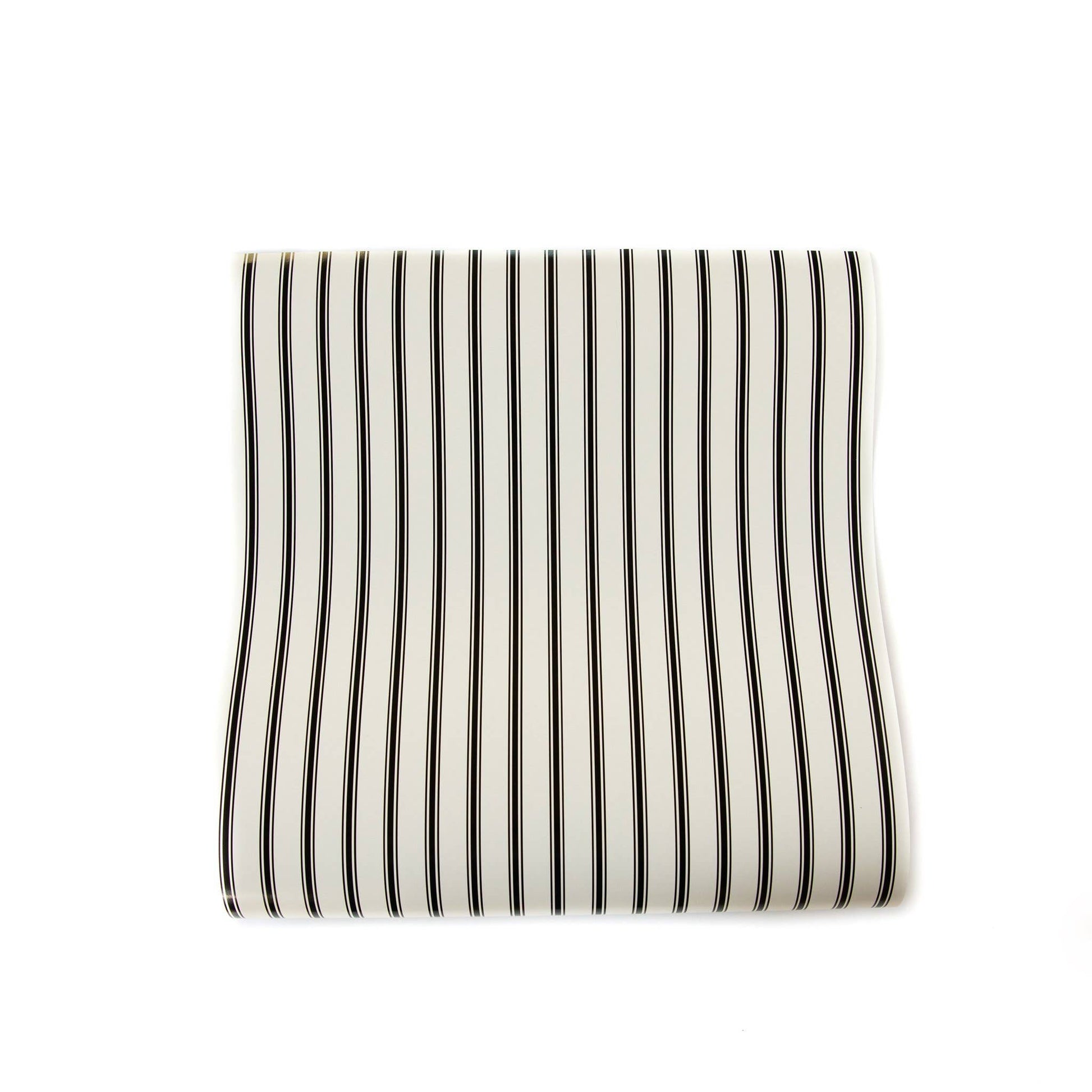 Striped paper table runner with black and white stripes on a white background
