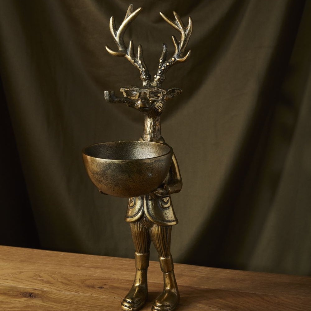 A decorative dish stand designed as a figurine of a deer with a dish on its head.
