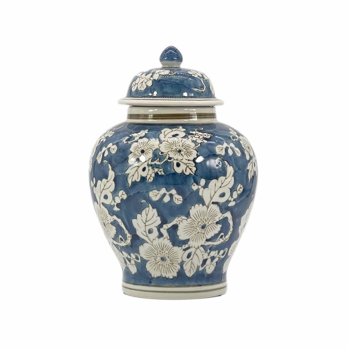 Blue ceramic jar with white floral patterns on a white background