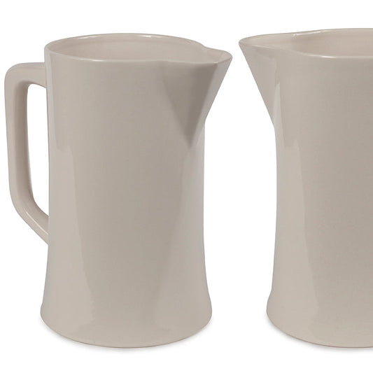 Three stoneware pitchers displayed side by side with a simple white design.