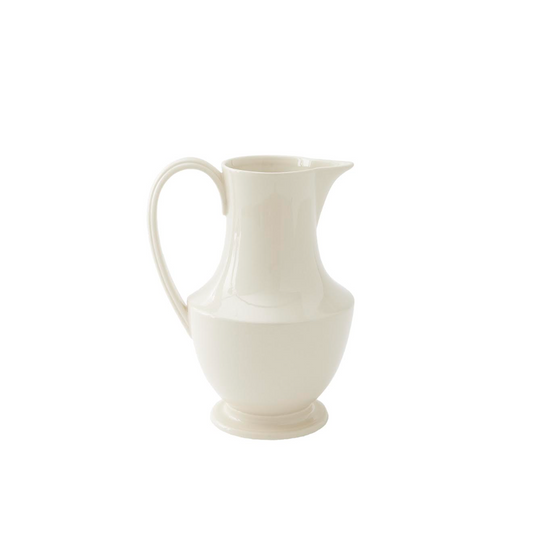 A white ceramic pitcher with a smooth, sleek design on a plain background.