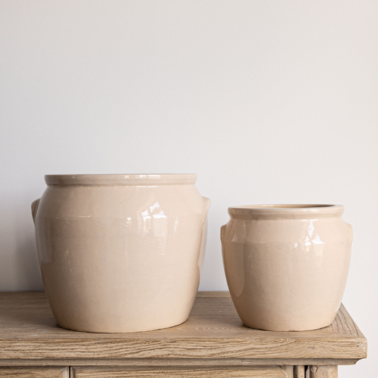 Two beige ceramic pots on a wooden surface with a light gray background
French Replica Cream Glazed Confit Crock Pot Large