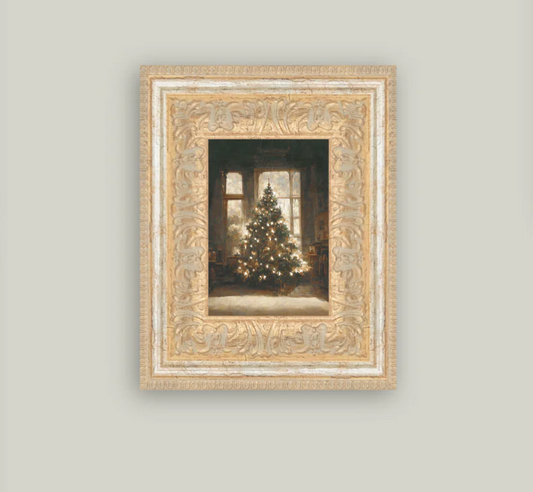 A framed vintage art piece depicting a glowing Christmas tree inside a house, with intricate gold detailing on the frame.