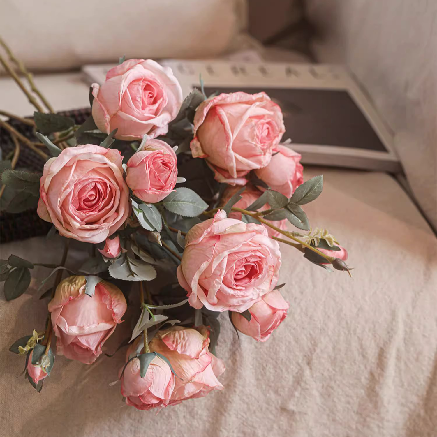 Bouquet of pink roses on a textured surface