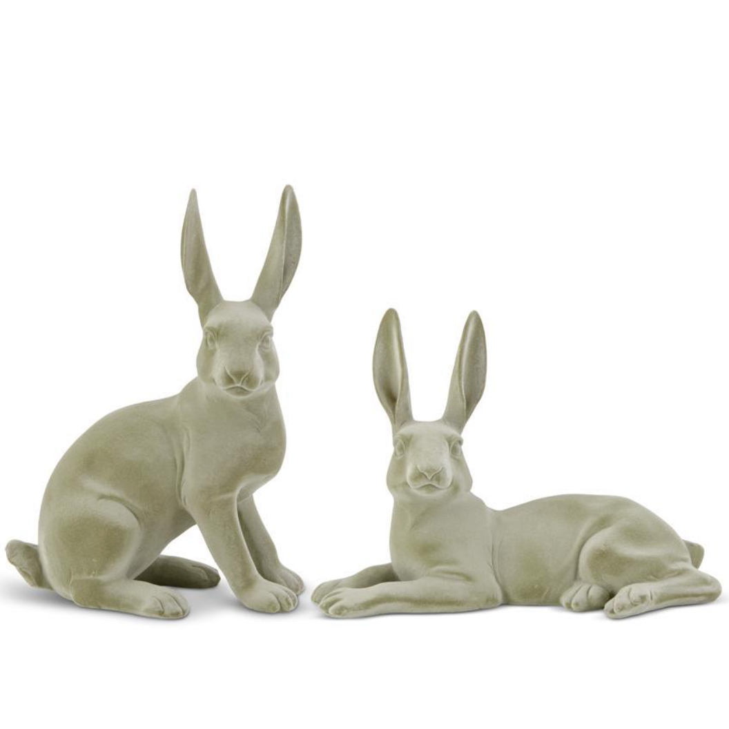 Two green velvet resin bunnies in graduated sizes, one sitting and one lying down, against a white background.
