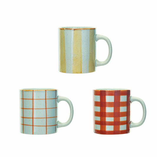 Three ceramic mugs with different patterns on a white background