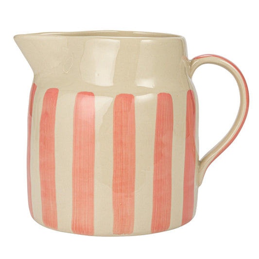 A beige stoneware pitcher with pink stripes, with a handle on the right side and a spout on the left.