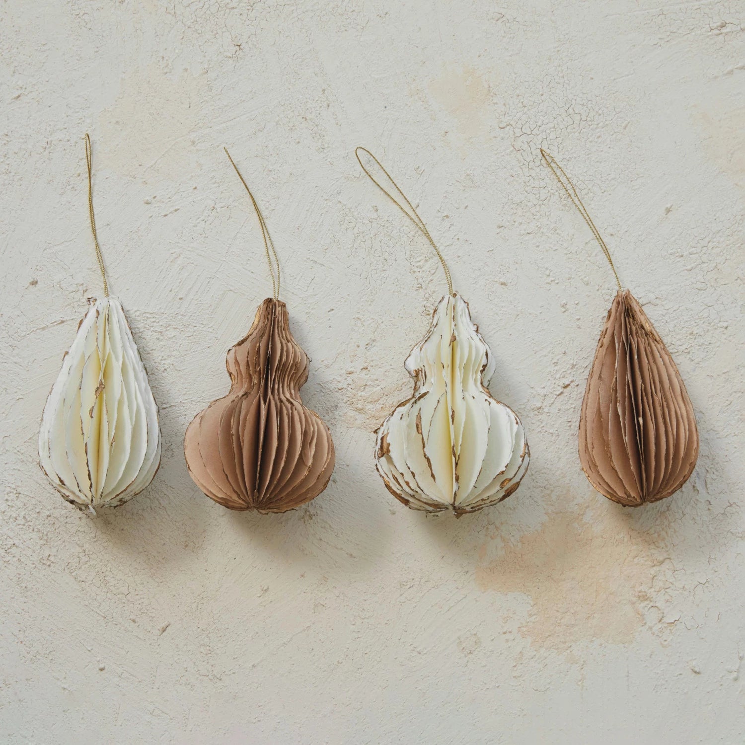A collection of honeycomb finial ornaments in various designs, with gold foil edges, displayed against a neutral background.