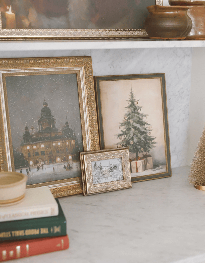 A vintage framed art print of ice skating scene, with a golden frame, displayed on a shelf.
