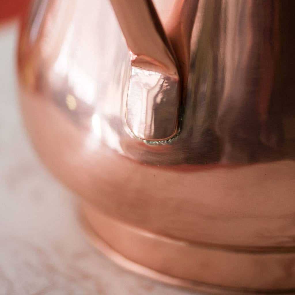 Close-up of a copper pitcher.