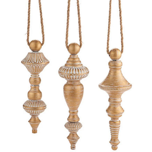 Three decorative finials hanging from strings on a white background