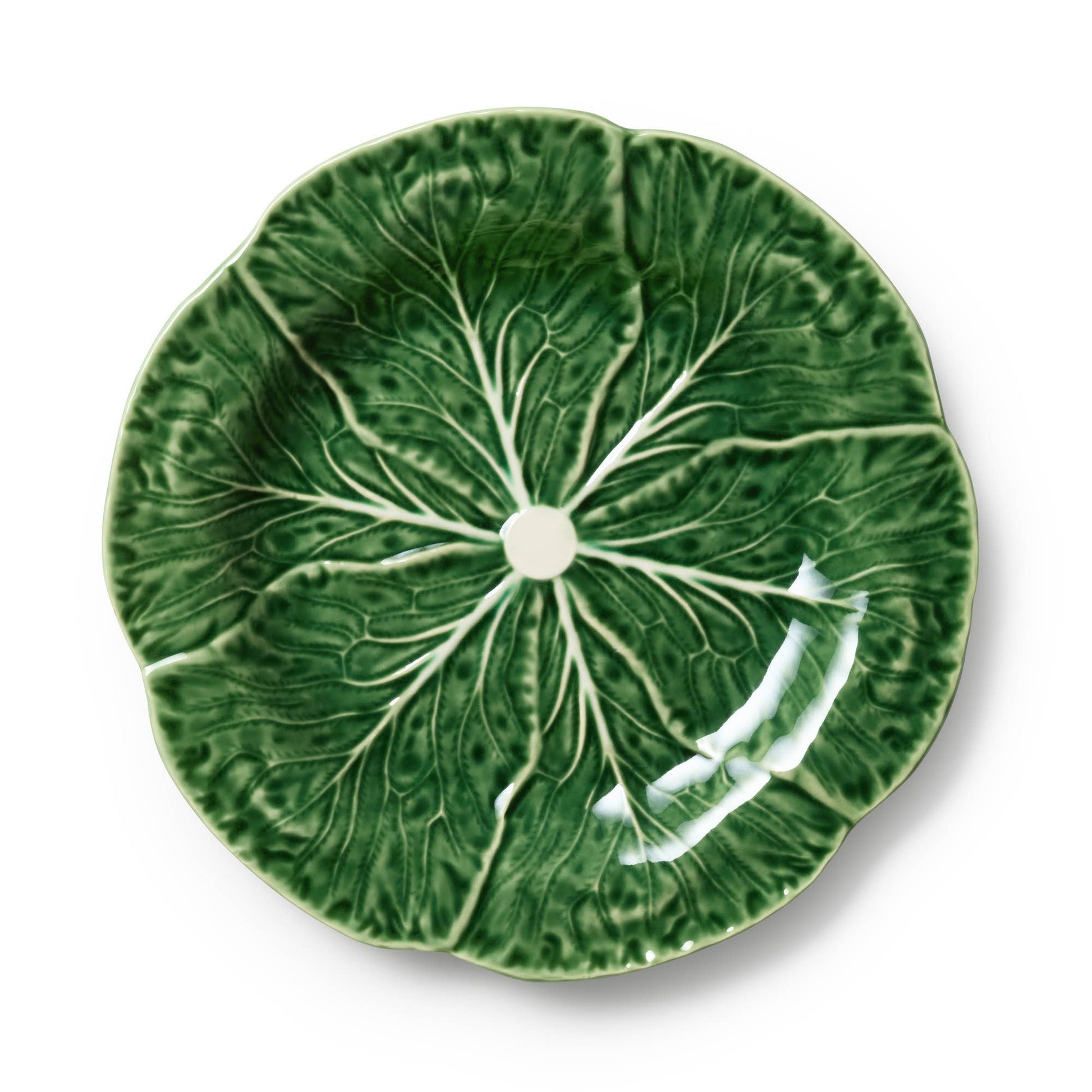 Green ceramic plate with cabbage leaf design on a white background