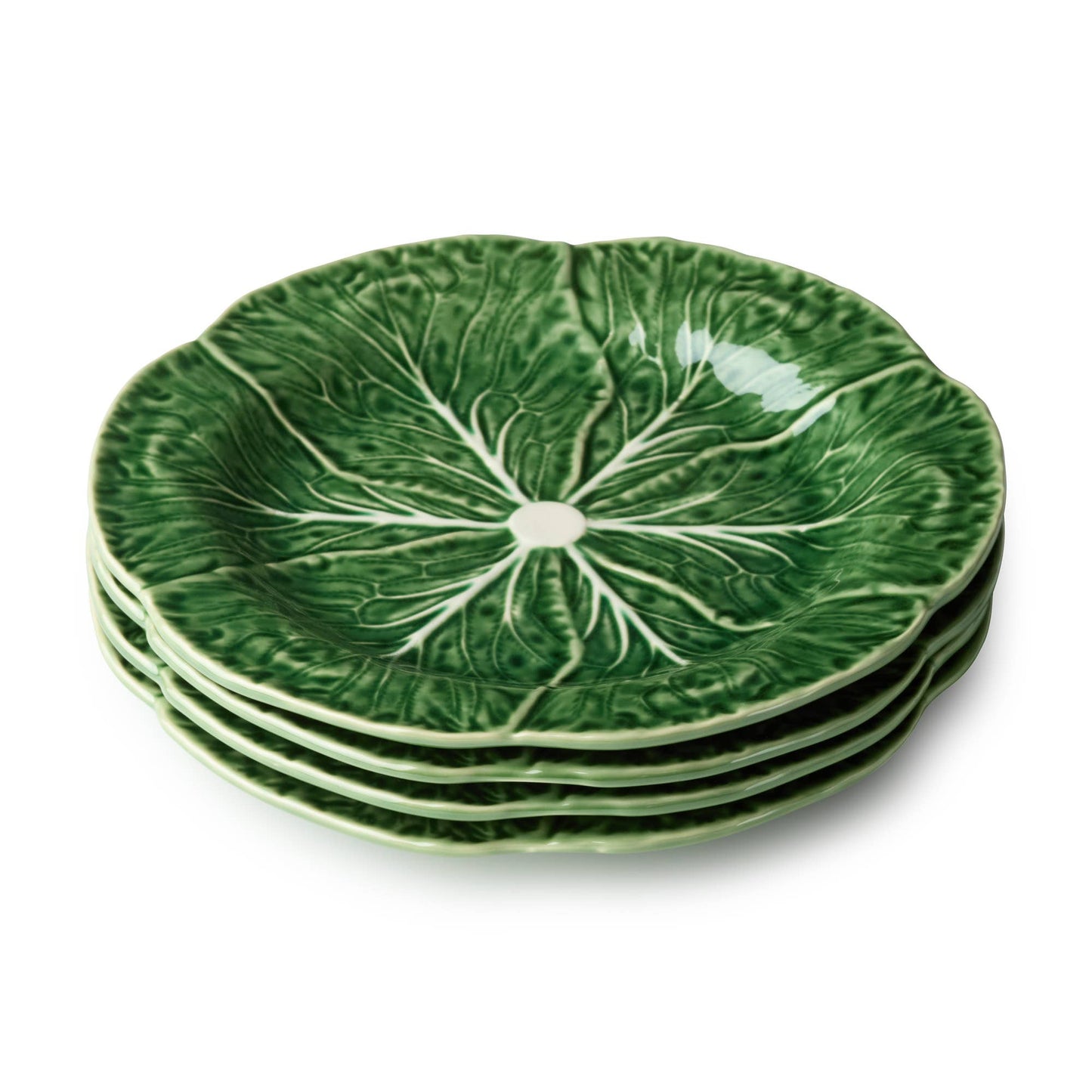 Stack of green ceramic plates with leaf pattern on a white background