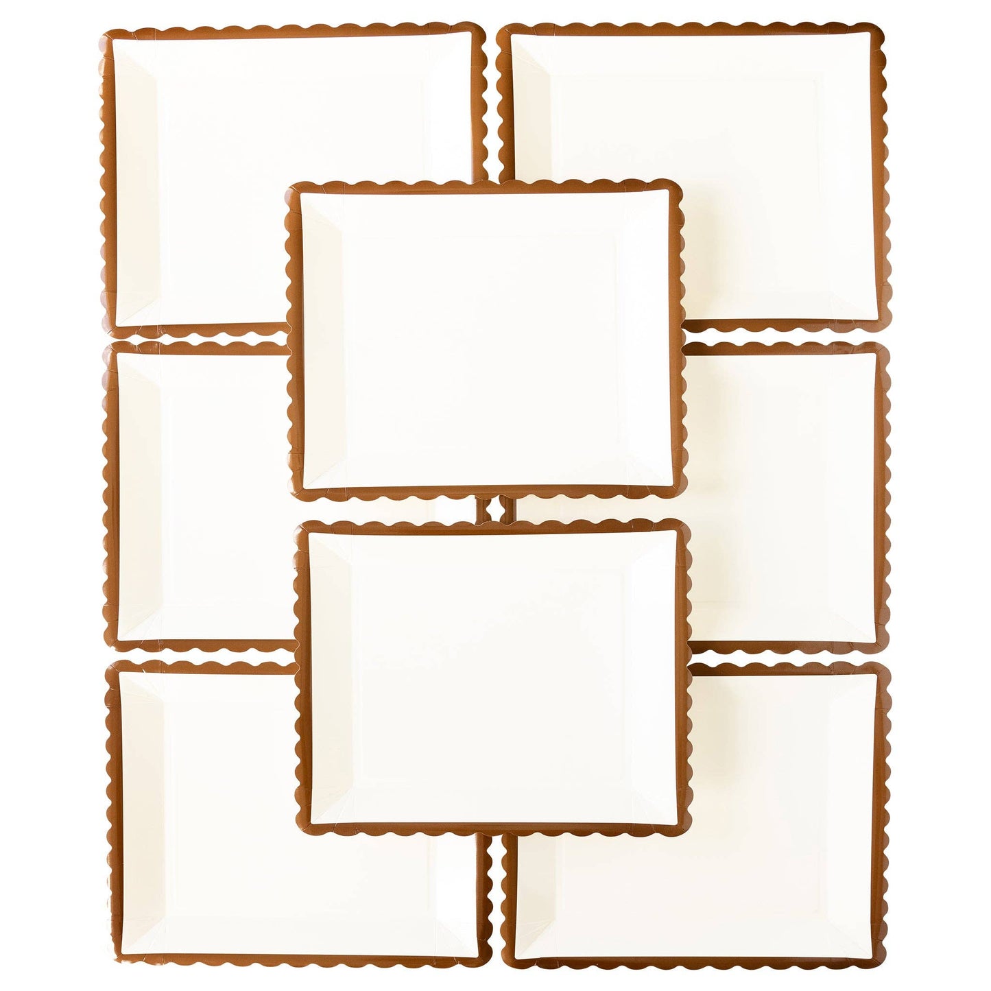 Set of white plates with brown scalloped edges on a white background