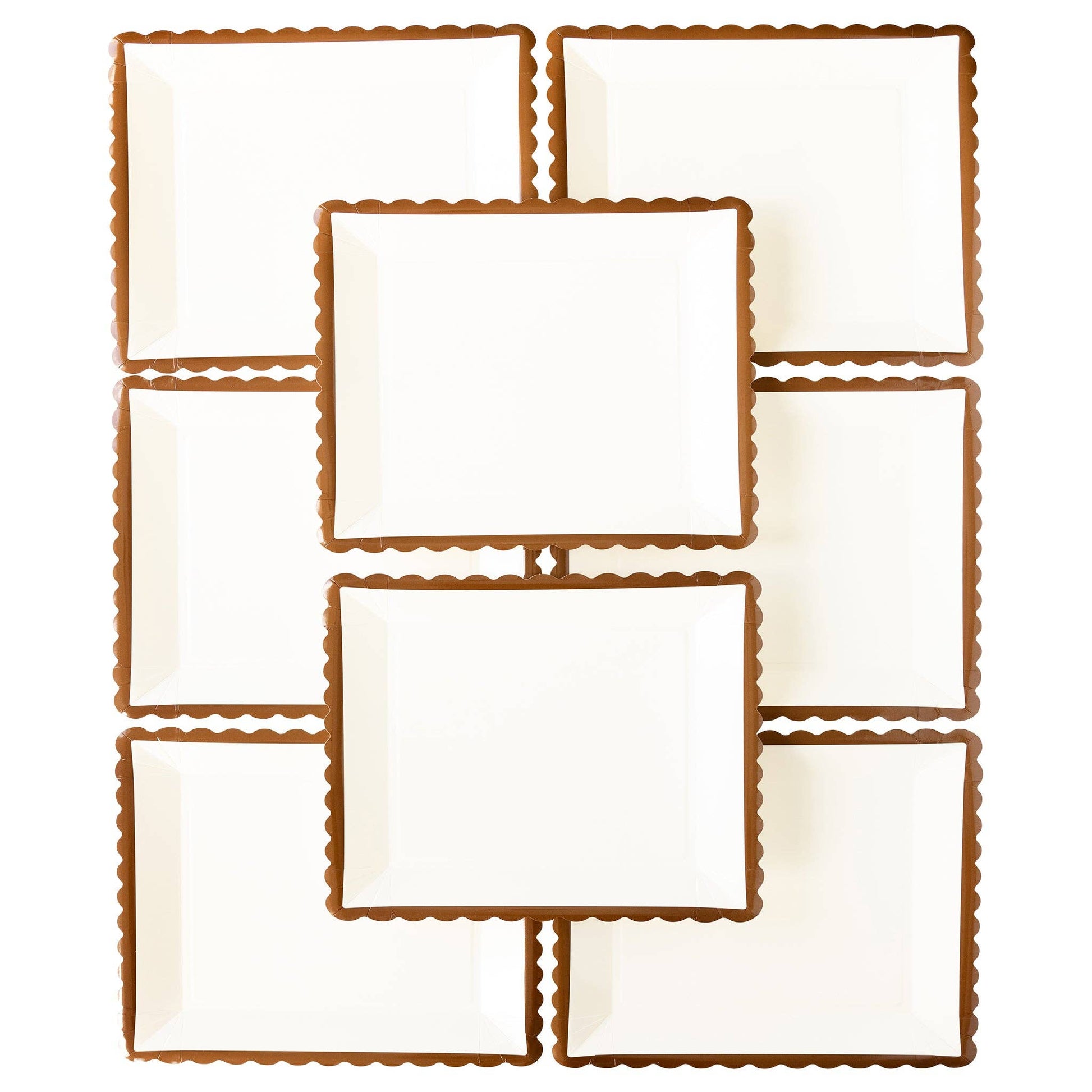 Set of white plates with brown scalloped edges on a white background