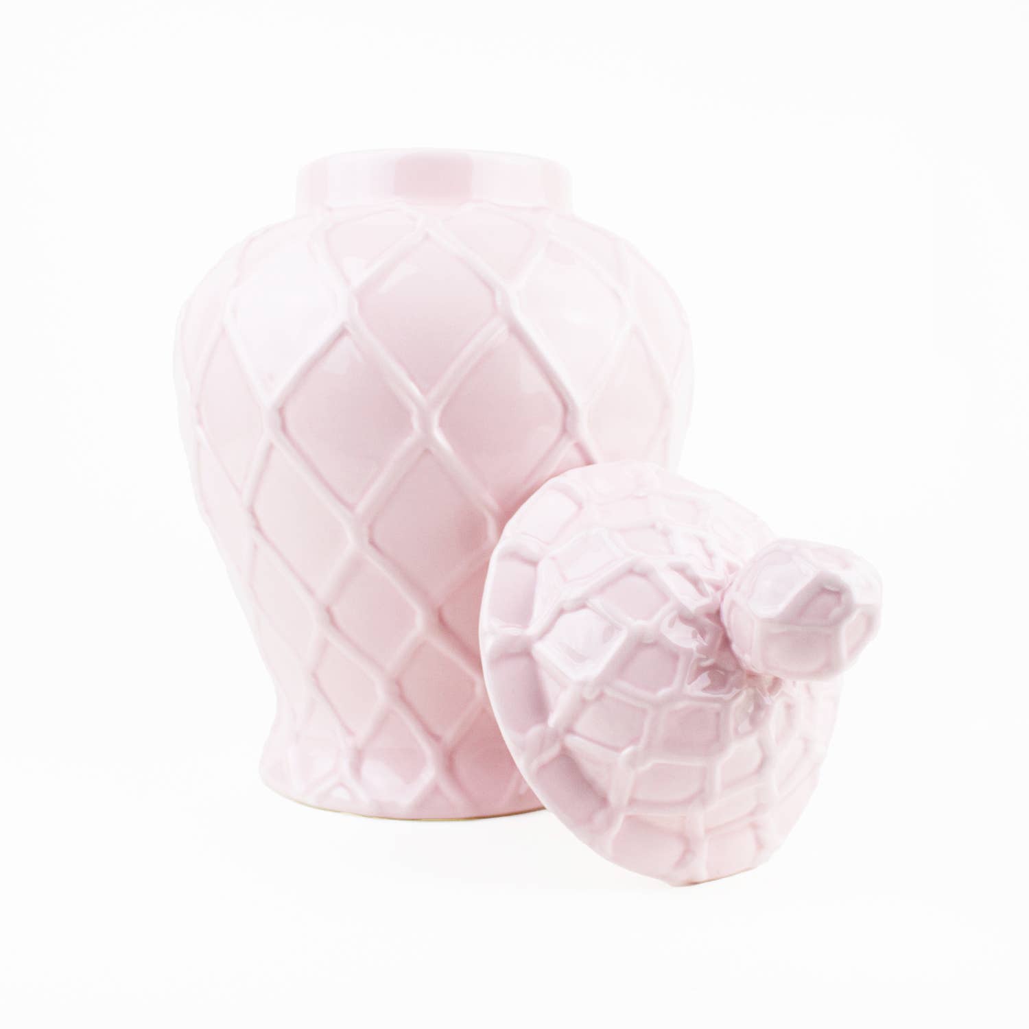 Two pink textured ceramic jars on a white background