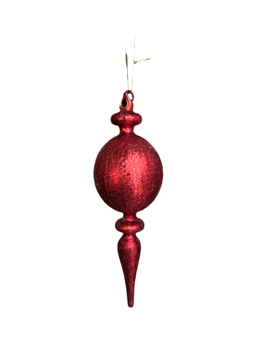 A hand blown glass red finial Christmas ornament with a textured surface, hanging from a ribbon.
