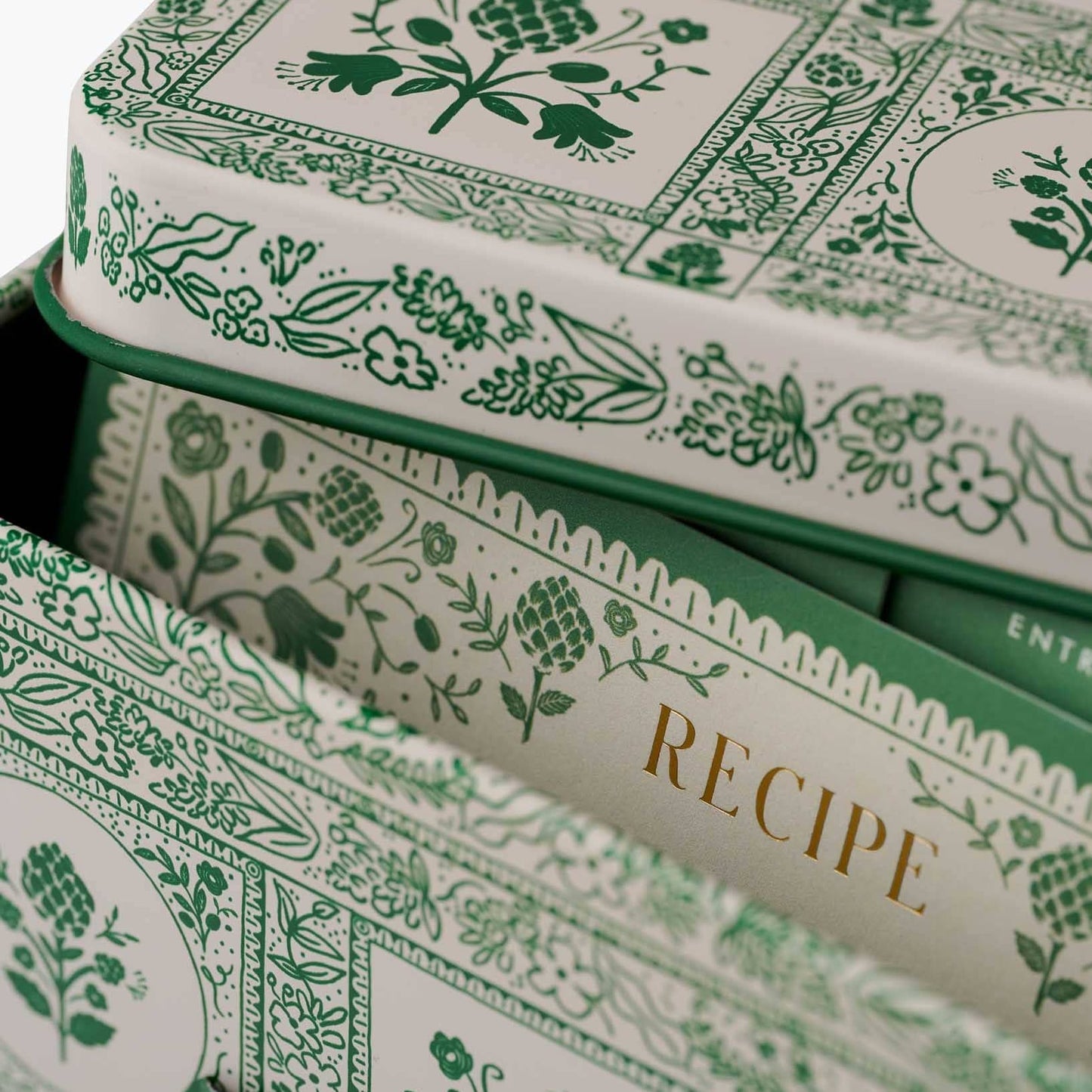Stack of recipe books with green floral patterns on a white background Rifle Paper Co. Artichoke Recipe Tin